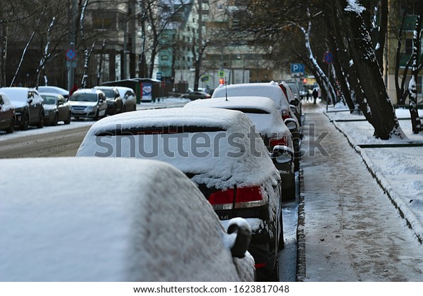 snow-covered cars\
on the street on a winter\
morning