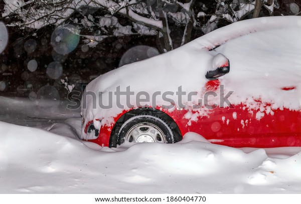 Snow-covered cars stuck in snowdrifts. Blizzard in\
the city