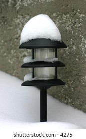 snow-covered garden light
