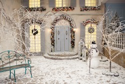 Snow-covered House And Yard Decorated For Christmas And New Year.  Vintage Courtyard Interior With Stairs, Porch, Door And Lights In Windows. Winter Christmas Back