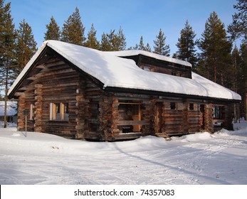 Snow-covered log cabin in a holiday resort in Yllas, Lapland, Finland. - Powered by Shutterstock