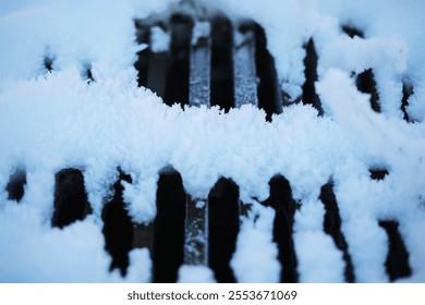 Snow-Covered Metal Grate with Frosty Patterns in Winter Urban Environment - Powered by Shutterstock