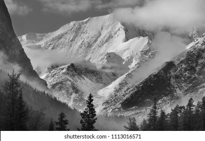 Snow-covered mountain peaks in the clouds, Altai mountains, black and white landscape - Powered by Shutterstock