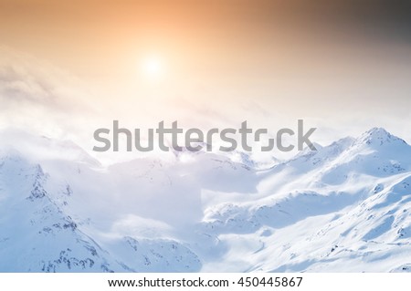 Snow-covered mountains at sunset. Beautiful winter landscape.