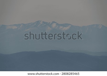 Snow-covered range glowing through evening haze, Hokkaido, Japan
