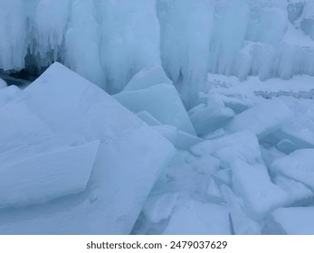 A snow-covered riverbank with ice chunks along the shore - Powered by Shutterstock