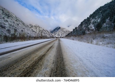 snow-covered road between the mountains