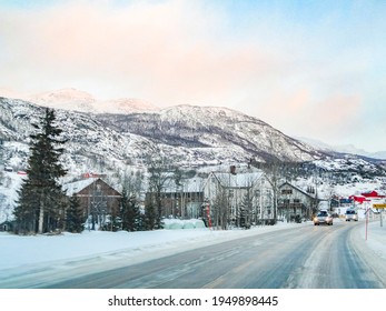 Snow-covered road through the center of Hemsedal in Viken, Norway in a winter landscape.