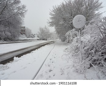 Snow-covered roads and pavements. Road sign covered with snow. Winter attack in Germany. Heavy snowfall in Heiligenhaus. Winter 2021