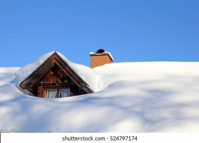 A Snow-covered Roof Of A Wooden House