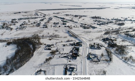 Snow-Covered Russian Village. Aerial View. Quadrotor Filming
