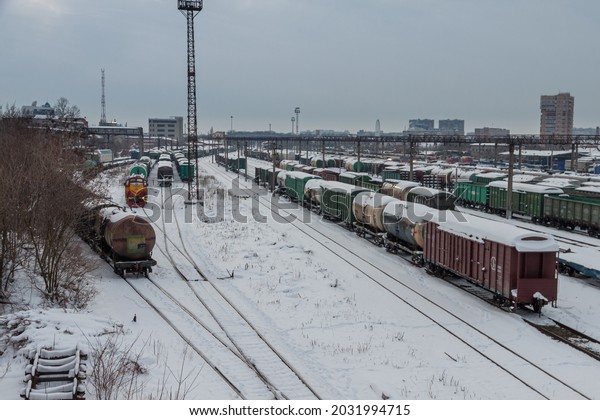 Snow-covered train station with different types of\
cars on the track. The concept of rail transport. Krasnodar,\
Russia, February 18,\
2021