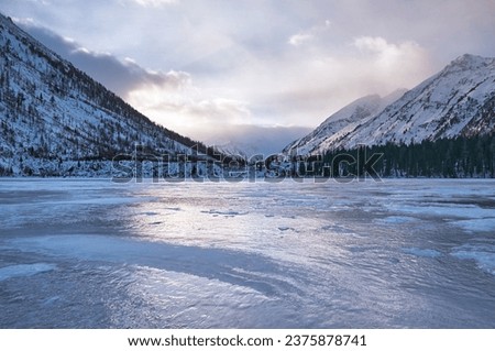 Snow-covered winter mountain lake, Russia, Siberia, Altai mountains. Multinskie lakes.