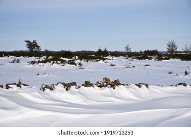 Snowdrift By An Old Dry Stone Wall In A Great Plain Landscape