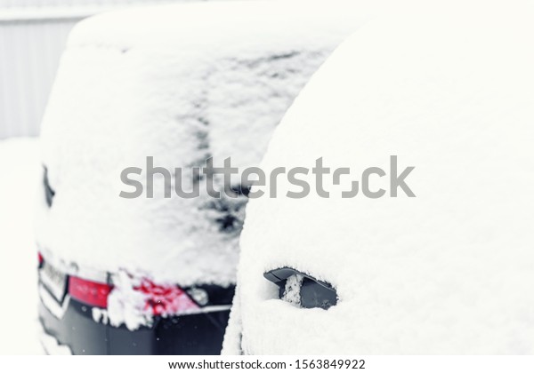 \
Snowdrift of snow by car. Car standing in snow. Snow covered car.\
Winter, snow, car in snowdrift. Space for\
text.