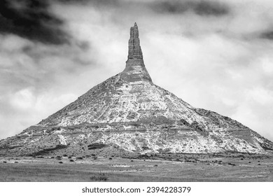 Snow-dusted winter landscape in classic black and white of Chimney Rock National Monument in Nebraska. - Powered by Shutterstock