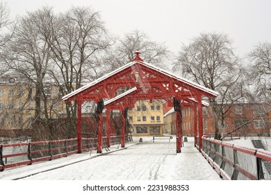 Snowfall in Norwegian city Trondheim, view of the snowy The Old Bridge (Den Gamle Bybro) - Shutterstock ID 2231988353