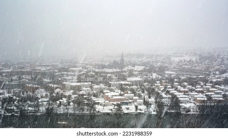 Snowfall in Norwegian city Trondheim, view of the river Nidelva, the cathedral Nidarosdomen and historic downtown - Shutterstock ID 2231988359