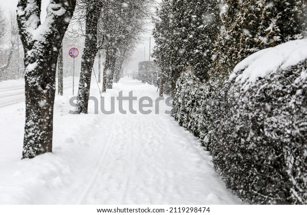 Snowfall. Snowy and dusty city streets.\
Slippery sidewalk.