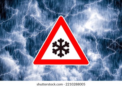 Snowfall warning sign in front of dramatic blue-gray cloudy sky with precipitation and lightning
