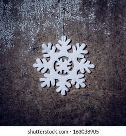 Snowflake decoration with rustic background.