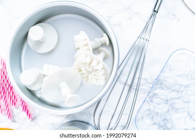 Snowflake Shape Plastic Cookie Cutter In A Cake Pan.