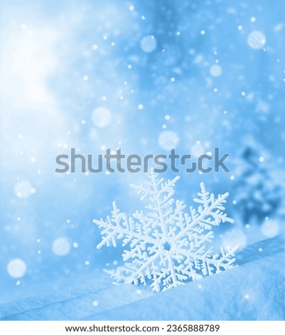 Snowflake shaped bokeh. Combined with blue background. Christmas concept.
