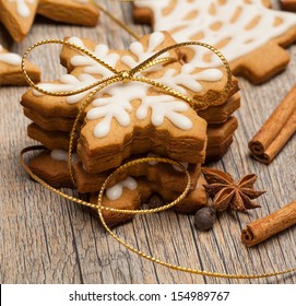Snowflake Shaped Gingerbread Cookies Stacked And Tied With A Gold Bow.