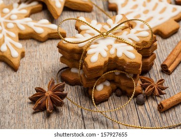 Snowflake Shaped Gingerbread Cookies Stacked And Tied With A Gold Bow.