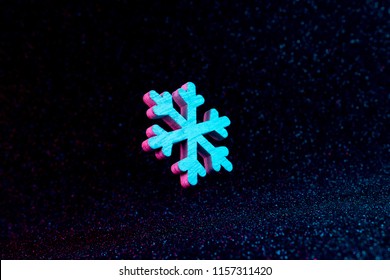 Snowflake In Vivid Neon Colors. Christmas Or Winter Dark Background  Concept.