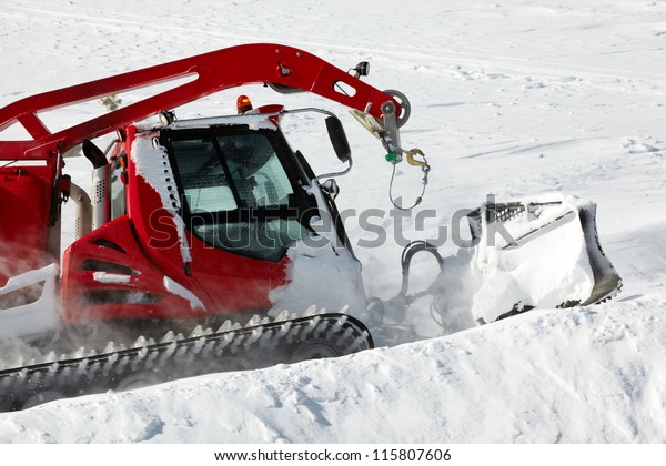 Snow-grooming machine on snow\
hill