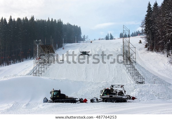 Snow-grooming machine on snow hill\
ready for skiing slope preparations in Ukrainian\
Carpathian