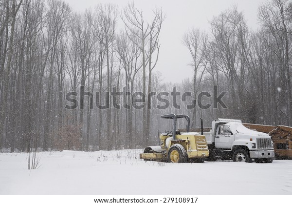 Snowing in the\
forest with trucks and\
vehicles