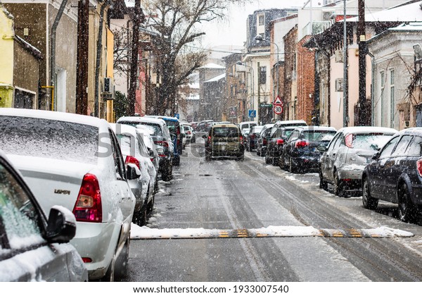 Snowing on cars in the morning, snow on street in\
Bucharest, Romania,\
2021