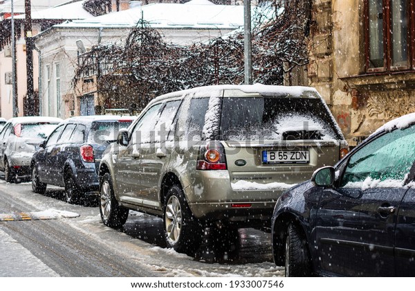 Snowing on cars in the morning, snow on street in\
Bucharest, Romania,\
2021
