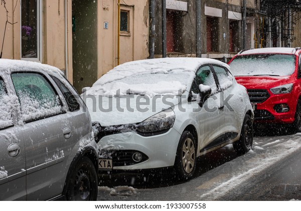 Snowing on cars in the morning, snow on street in
Bucharest, Romania,
2021
