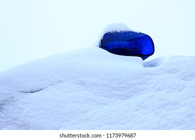 It's Snowing Outside. Police Car All In The Snow. Only Flashing Lights Are Visible.