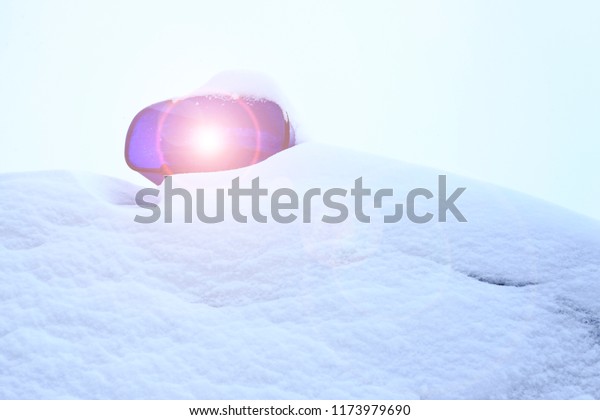 it\'s snowing outside. police car all in the\
snow. only flashing lights are\
visible.