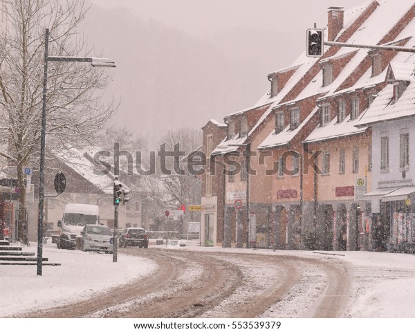 Snowing in a street. A\
town in Germany.
