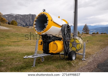 Snowmaking machine on alpine ski slope in Dolomites mountains