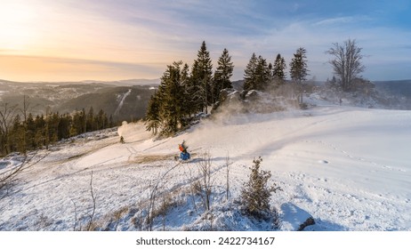 Snowmaking in the mountains in early winter. Tanvaldsky Spicak ski resort in Jizera Mountains, Czech Republic