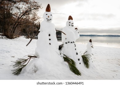 Snowman Family At Lake Tahoe In Winter With Snow On The Beach, California, USA