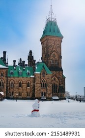 Snowman In Front Of The Canadian Parliament Building In Ottawa, Capital Of Canada At Winter