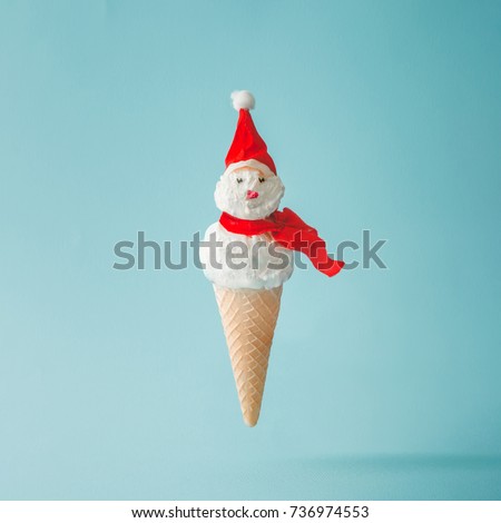 Snowman made of ice cream on bright blue background. Winter holiday concept.