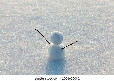 the snowman is made of several parts and stands in the snow in cold weather, one small snowman in the winter season, snow games with the creation of one snowman figure