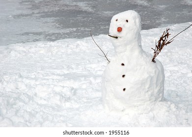 Snowman near frozen lake - Shutterstock ID 1955116
