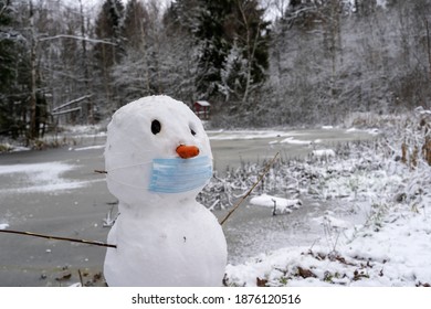 Snowman In A Protective Mask In The Snow