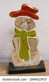 snowman wearing red cap and green scarf