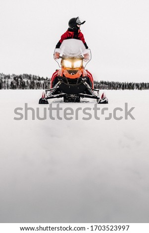 Snowmobil tour in the Winterwonderland. Holidays in Finland Lapland. Beautiful snowlandscape. 