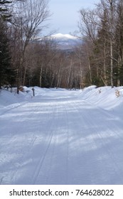 Snowmobile And Hiking Trail Covered In Snow In Winter On Bald Mountain In Rangeley, Maine, With A View Of Kennebago Mountain In The Distance.